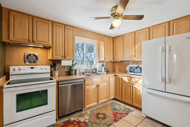 kitchen with tasteful backsplash, stainless steel appliances, sink, and light tile patterned floors