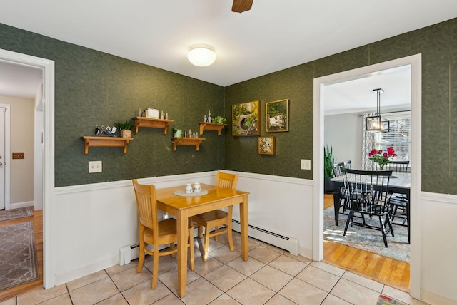 dining space featuring baseboard heating and tile patterned flooring