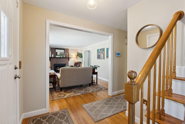 entrance foyer featuring a fireplace and wood-type flooring