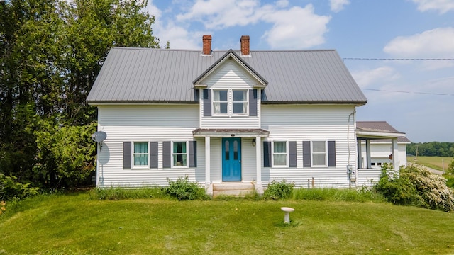 2382 Exeter Rd, Exeter, ME 04435 - view of front facade with a chimney, a front yard, and a metal roof