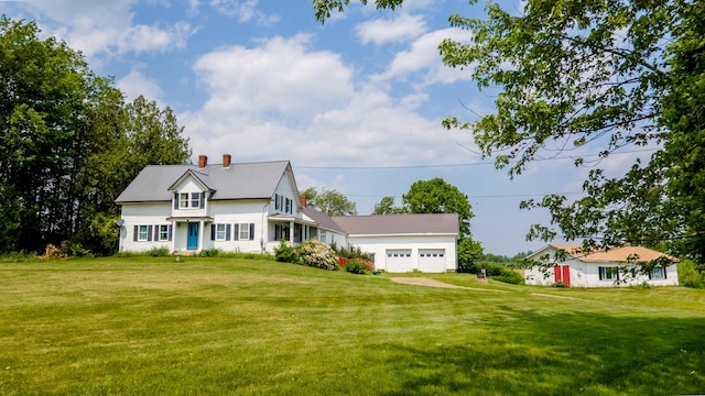2382 Exeter Rd, Exeter, ME 04435 - view of front facade with a chimney, a front yard, and a metal roof