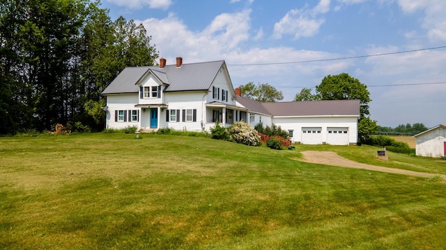 2382 Exeter Rd, Exeter, ME 04435 - view of front of property with a chimney, a metal roof, a front yard, a garage, and driveway