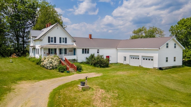 2382 Exeter Rd, Exeter, ME 04435 - view of front facade featuring dirt driveway, a garage, a chimney, a front yard, and a metal roof