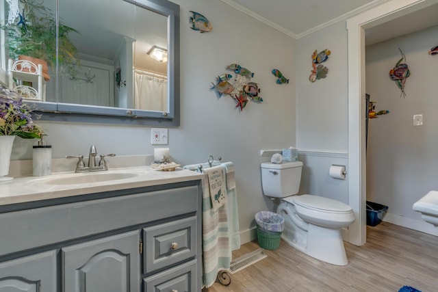 54 Webhannet Dr, Wells, ME 04090 - bathroom featuring toilet, wood finished floors, baseboards, vanity, and ornamental molding