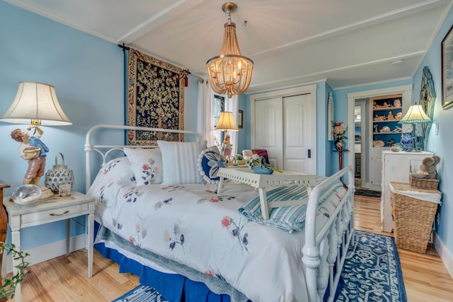 54 Webhannet Dr, Wells, ME 04090 - bedroom featuring a chandelier, wood finished floors, a closet, and crown molding