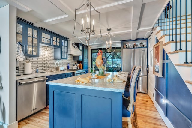 54 Webhannet Dr, Wells, ME 04090 - kitchen featuring appliances with stainless steel finishes, a chandelier, blue cabinetry, coffered ceiling, and beamed ceiling