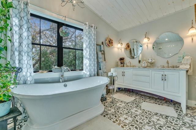 54 Webhannet Dr, Wells, ME 04090 - full bath featuring double vanity, a freestanding bath, vaulted ceiling, wooden ceiling, and tile patterned floors