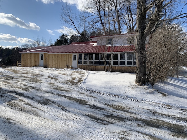 view of snow covered rear of property