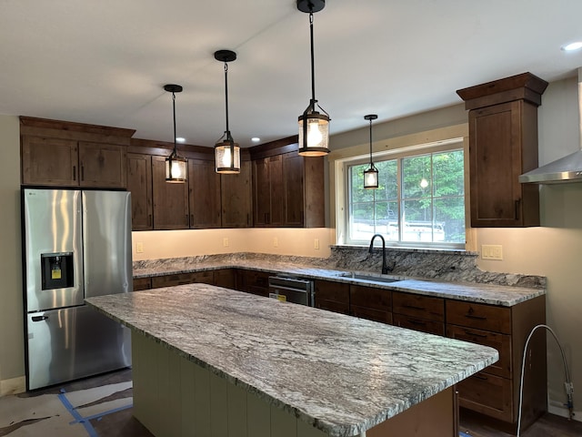 15 Rileys Run, Bridgton, ME 04009 - kitchen featuring stainless steel fridge, a sink, light stone counters, dark brown cabinetry, and a kitchen island