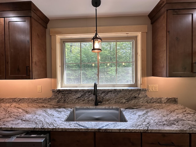 15 Rileys Run, Bridgton, ME 04009 - kitchen with a sink, hanging light fixtures, dark brown cabinetry, and light stone countertops