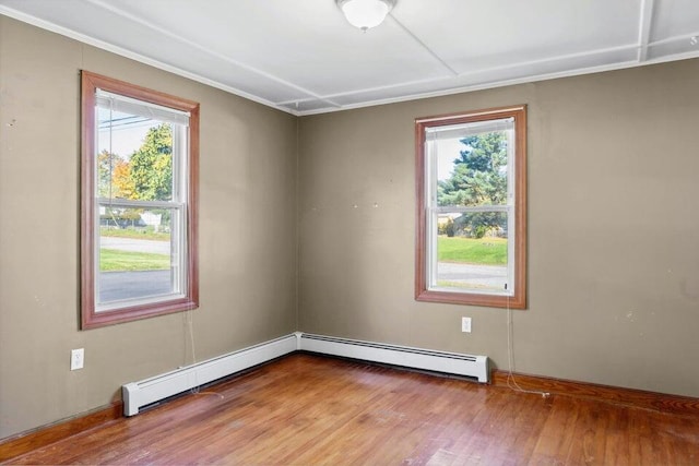 unfurnished room with light wood-type flooring and baseboard heating