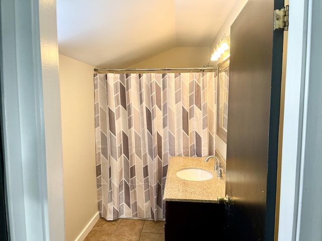 bathroom with vanity, tile patterned floors, and lofted ceiling