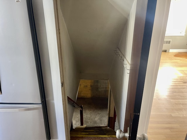 staircase with wood-type flooring