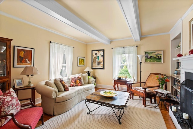 living room featuring beamed ceiling, a premium fireplace, ornamental molding, and light hardwood / wood-style flooring