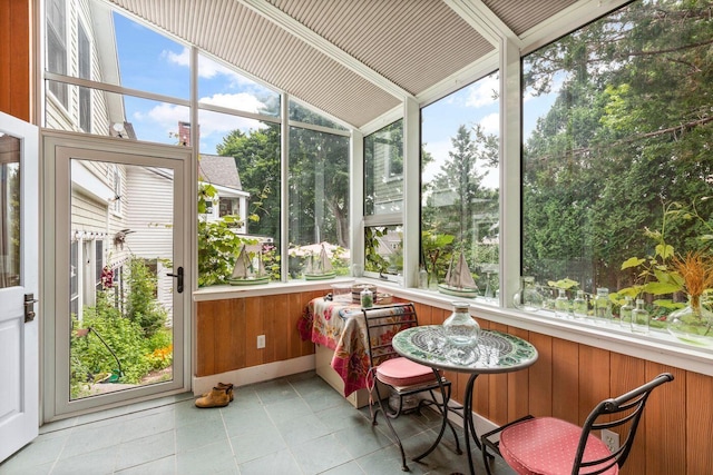 sunroom featuring vaulted ceiling