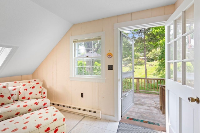 doorway with lofted ceiling with skylight, a baseboard heating unit, light tile patterned floors, and wooden walls