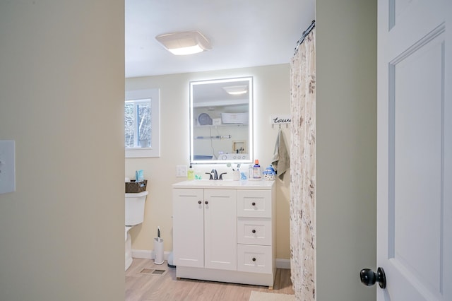 bathroom featuring vanity and hardwood / wood-style flooring