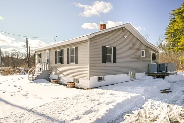 view of snow covered rear of property