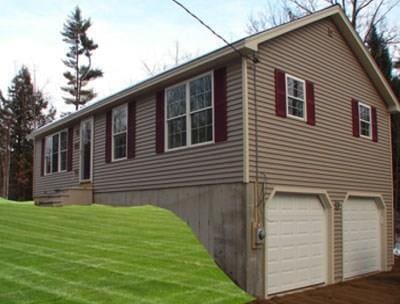 view of side of home with a garage and a yard