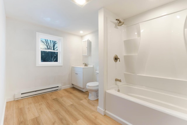 bathroom featuring wood finished floors, shower / washtub combination, vanity, a baseboard heating unit, and toilet