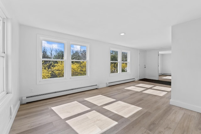 unfurnished living room featuring recessed lighting, baseboards, baseboard heating, and wood finished floors