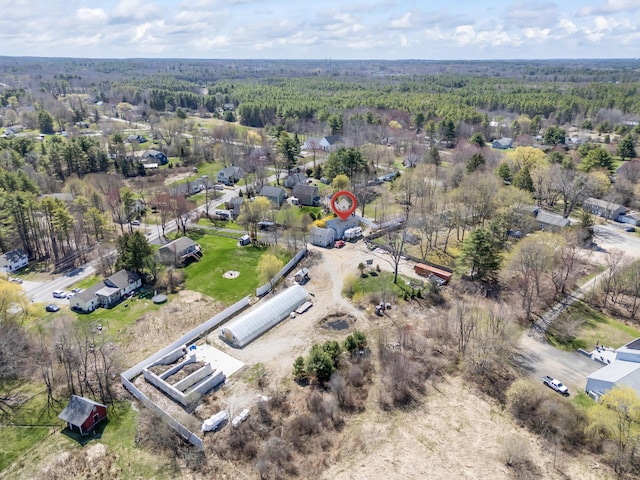 bird's eye view with a wooded view