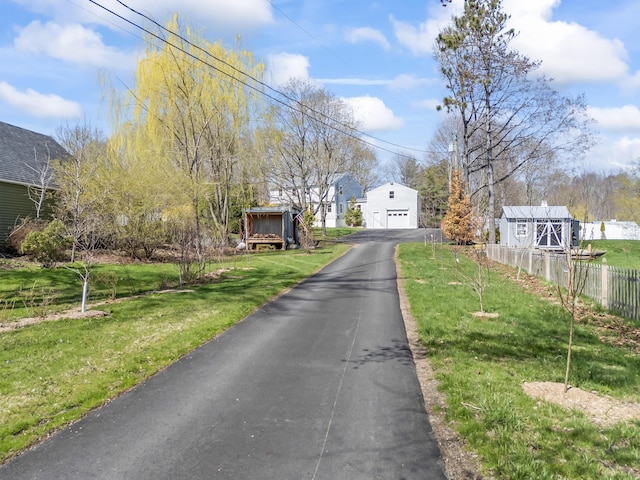 view of street featuring aphalt driveway