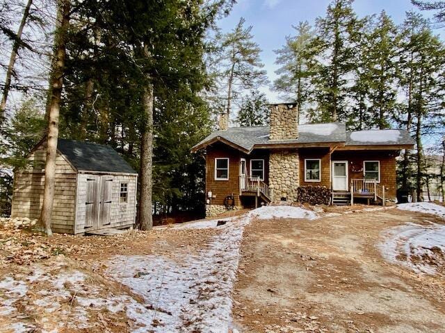 view of front of property with a storage shed