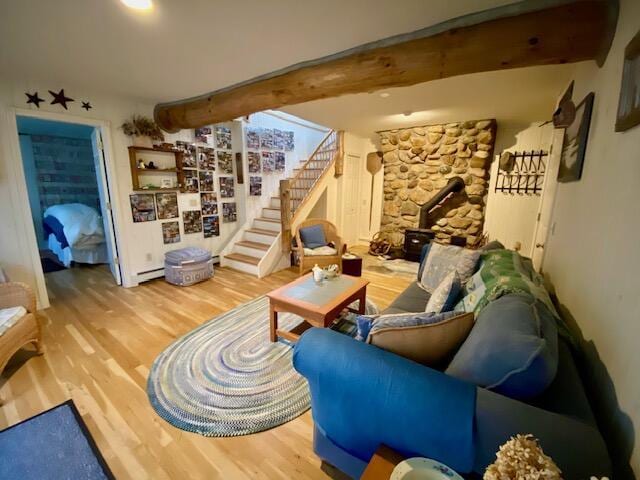 living room with hardwood / wood-style floors, beam ceiling, and a baseboard radiator