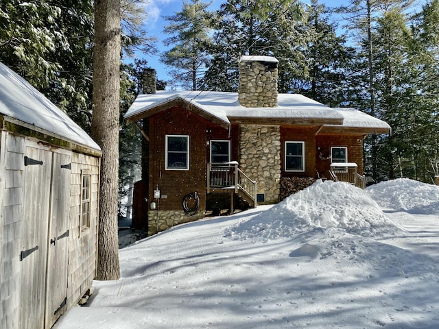 view of snow covered rear of property