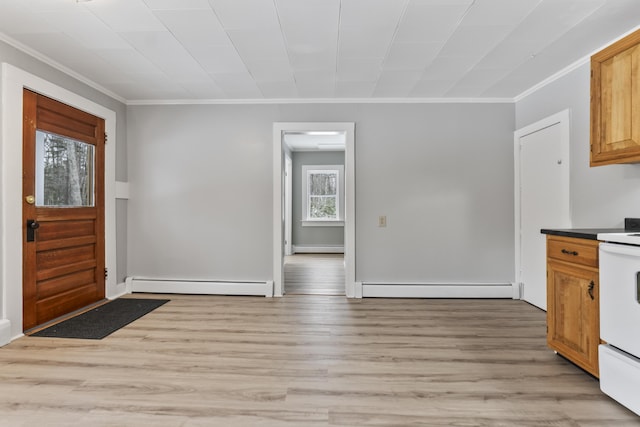 interior space with baseboard heating, ornamental molding, and light wood-type flooring