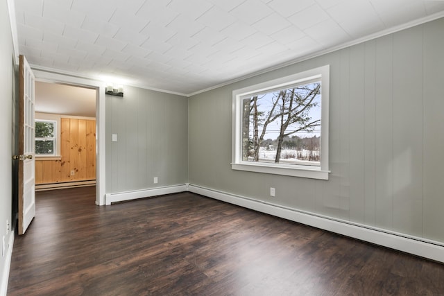 empty room featuring dark wood-type flooring, a baseboard radiator, and a healthy amount of sunlight