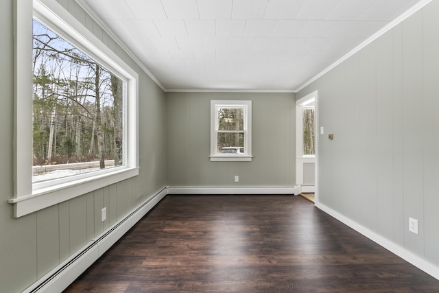 empty room with a baseboard radiator, ornamental molding, and dark hardwood / wood-style floors