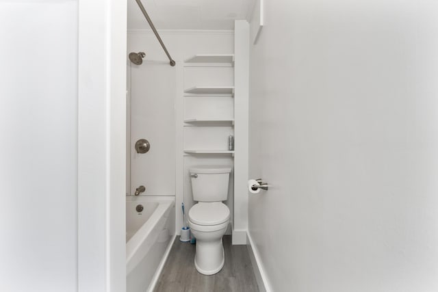 bathroom with wood-type flooring,  shower combination, and toilet