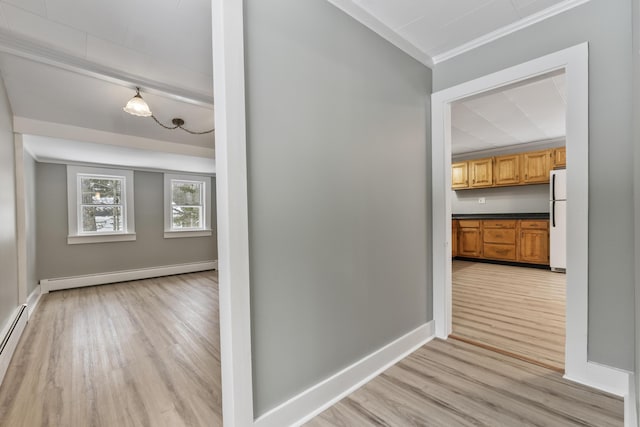 corridor with a baseboard heating unit, ornamental molding, and light wood-type flooring