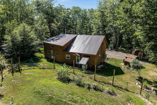 view of property exterior featuring a lawn and a shed