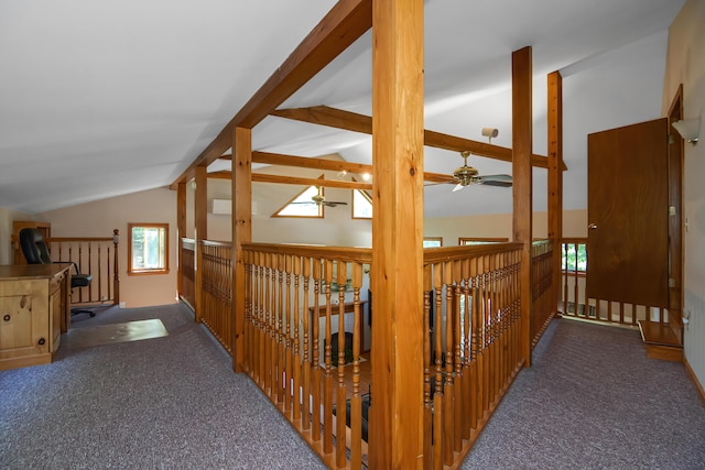 corridor featuring lofted ceiling with beams and dark colored carpet