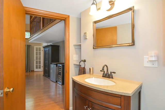 bathroom featuring vanity, wood-type flooring, and beverage cooler