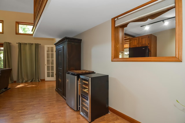 kitchen with black fridge and light wood-type flooring