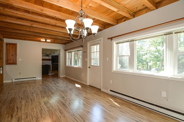 interior space with a healthy amount of sunlight, a baseboard radiator, and wood-type flooring