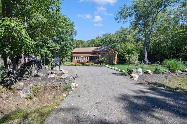 view of front of property with a front yard and a deck