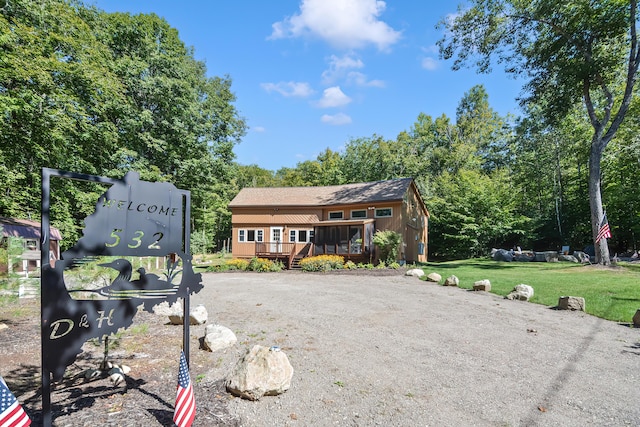 view of front of house featuring a front yard and a deck