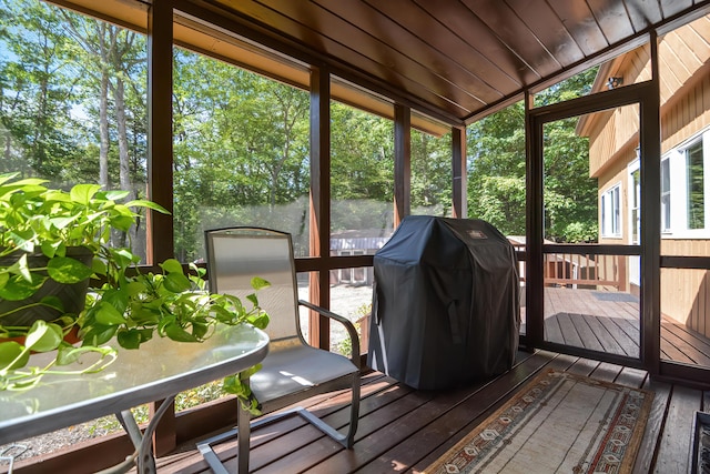 sunroom / solarium featuring vaulted ceiling and wooden ceiling