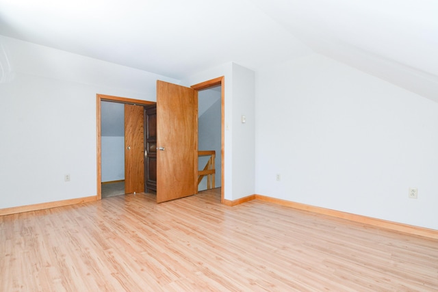 interior space with lofted ceiling and light wood-type flooring