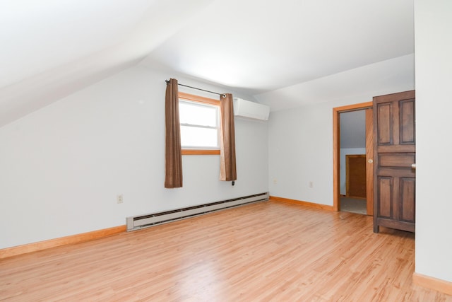 bonus room featuring a wall mounted air conditioner, vaulted ceiling, light hardwood / wood-style floors, and baseboard heating