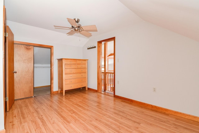 unfurnished bedroom with vaulted ceiling, light hardwood / wood-style floors, a closet, and ceiling fan