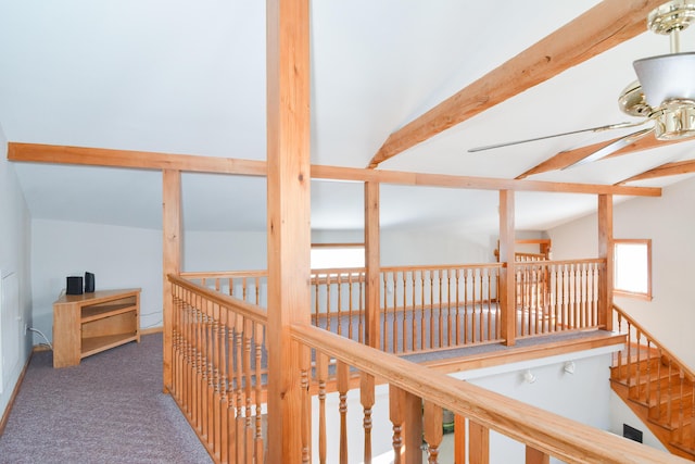 hall with lofted ceiling with beams and dark carpet