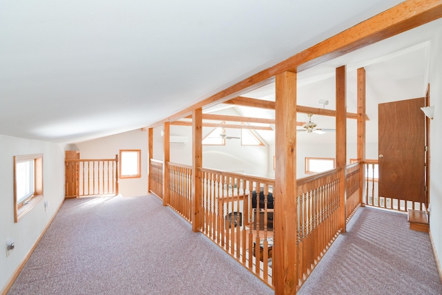 hallway featuring lofted ceiling with beams and carpet