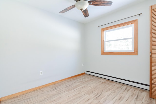 spare room with a baseboard radiator, ceiling fan, and light hardwood / wood-style floors