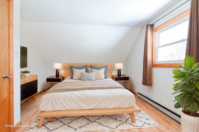 bedroom featuring a baseboard radiator, lofted ceiling, and light wood-type flooring